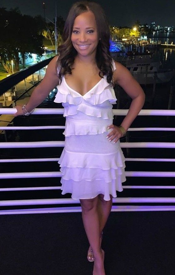 Dawn Hasbrouck in a white dress attending the a party